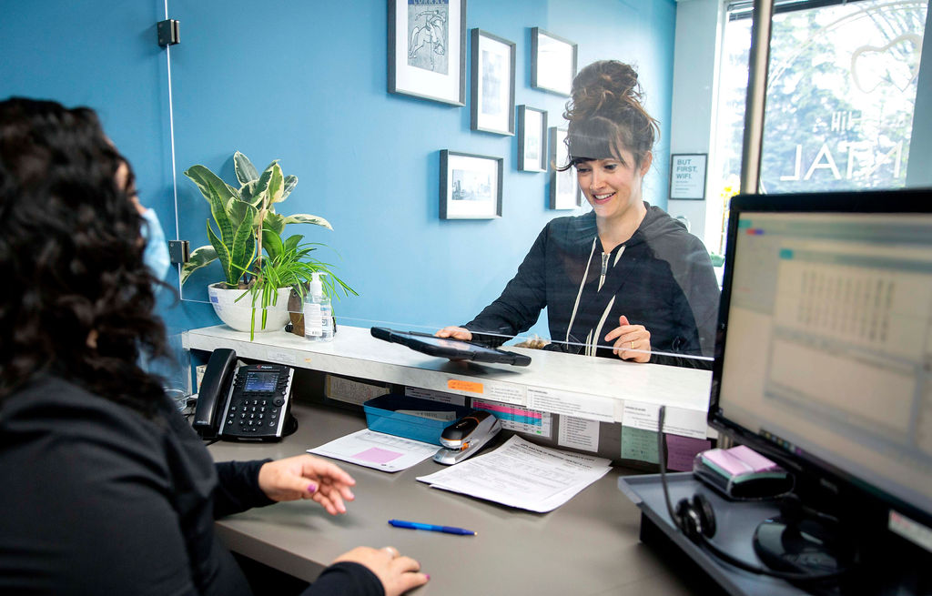 Women paying for her dental appointment at the reception