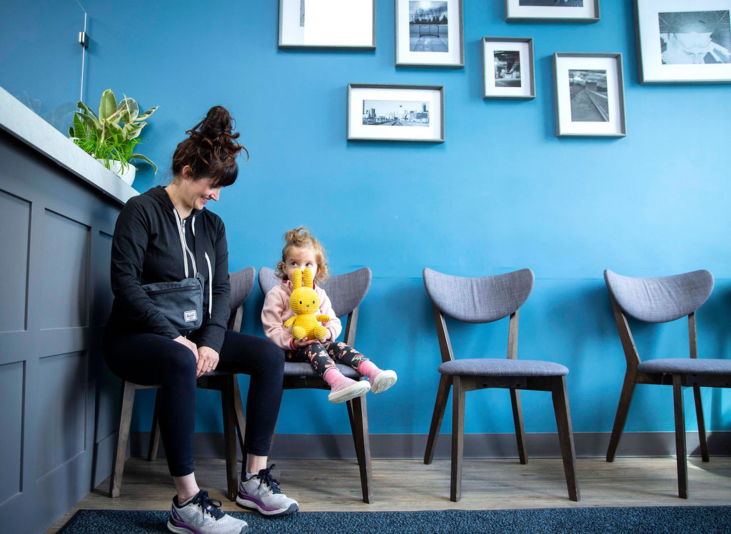 Young girl and her mother sitting in the waiting area at Briar Hill Dental